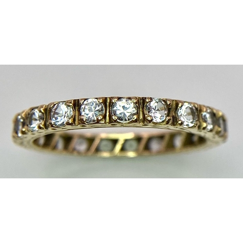 386 - A 9k yellow gold full eternity band ring set with cubic zirconia 2.5g, size R.