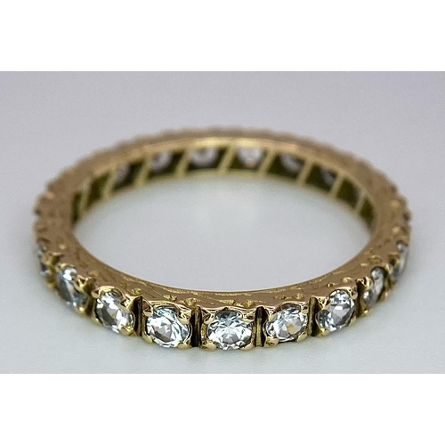 386 - A 9k yellow gold full eternity band ring set with cubic zirconia 2.5g, size R.