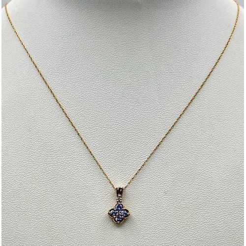 400 - A 9k yellow gold tanzanite and diamond floral cluster necklace and matching earrings. 2.3g total wei... 