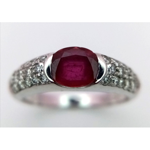 404 - AN 18K WHITE GOLD DIAMOND & RUBY RING.  0.40CT 4.4G SIZE M.