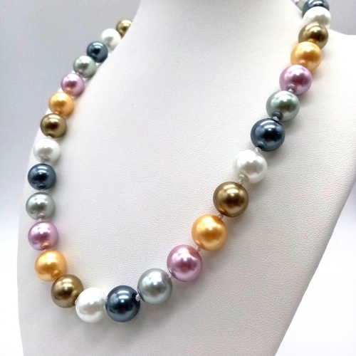 1038 - A Multi-Coloured South Sea Pearl Shell Bead Necklace. 12mm beads. 44cm length. Heart clasp.