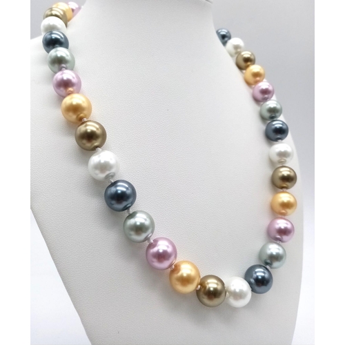 1038 - A Multi-Coloured South Sea Pearl Shell Bead Necklace. 12mm beads. 44cm length. Heart clasp.