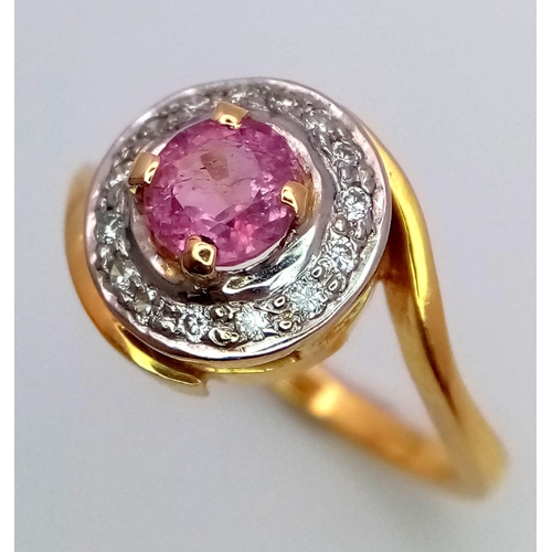 116 - An 18K YELLOW GOLD DIAMOND & PINK STONE (BELIEVED TO BE SAPPHIRE) CLUSTER RING. 5G. SIZE L.