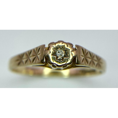 1207 - A 9k yellow gold diamond solitaire ring with starburst design engraved shoulders. 1.4g (dia:0.03ct) ... 