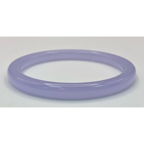 1325 - A Lilac Jade Coloured Thin Bangle. 6cm inner diameter. 8mm width.