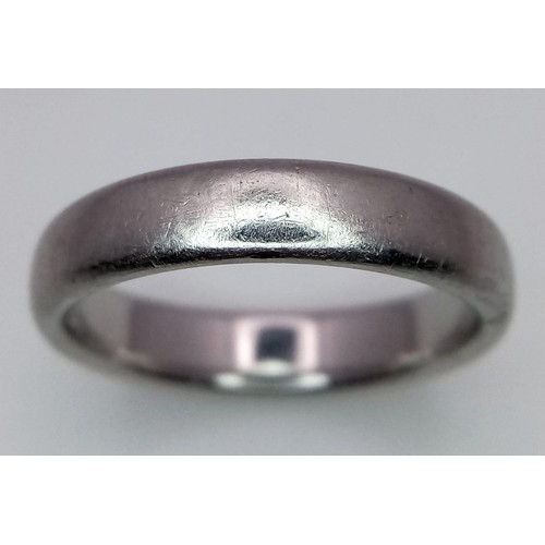 23 - A Tiffany and Co Platinum 4mm rounded band ring. 9.3g. Size Q.