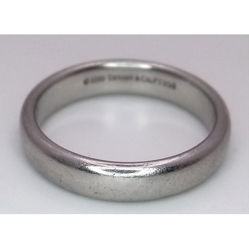 23 - A Tiffany and Co Platinum 4mm rounded band ring. 9.3g. Size Q.