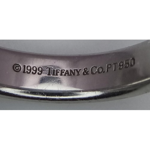 23 - A Tiffany and Co Platinum 4mm rounded band ring. 9.3g. Size Q.