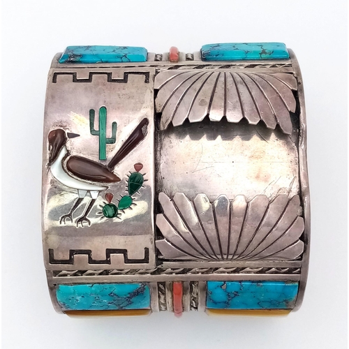 143 - A Vintage Silver Native American Cuff Bangle. Inlaid turquoise, mother of pearl and red coral create... 