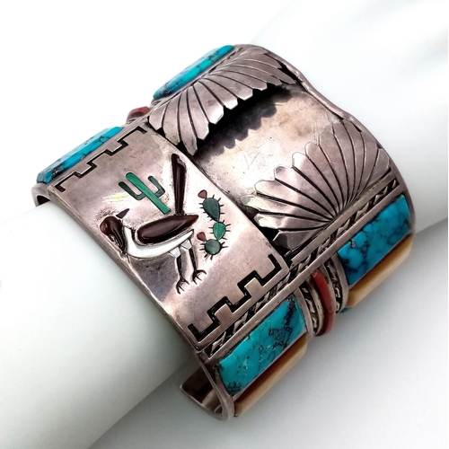 143 - A Vintage Silver Native American Cuff Bangle. Inlaid turquoise, mother of pearl and red coral create... 