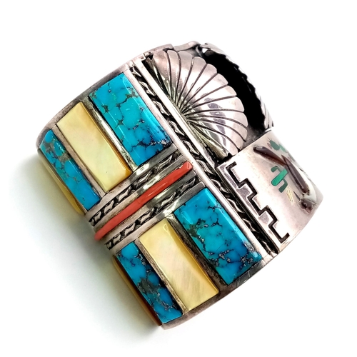 143 - A Vintage Silver Native American Cuff Bangle. Inlaid turquoise, mother of pearl and red coral create... 