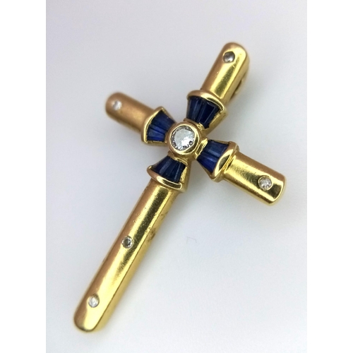 245 - AN 18K YELLOW GOLD DIAMOND & SAPPHIRE SET CROSS. 3.6G