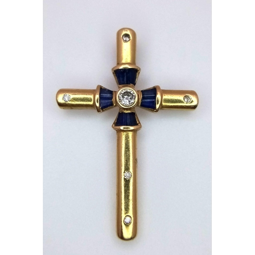 245 - AN 18K YELLOW GOLD DIAMOND & SAPPHIRE SET CROSS. 3.6G