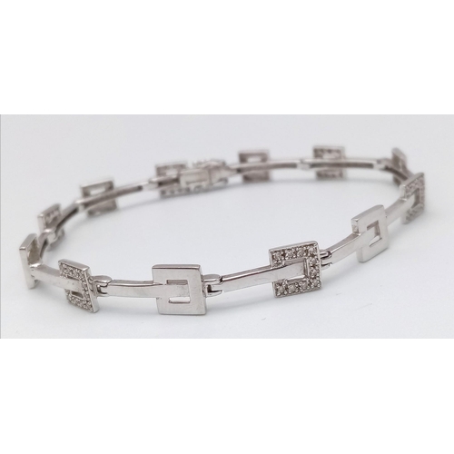 247 - A 9K WHITE GOLD DIAMOND SET BRACELET. 9.9G