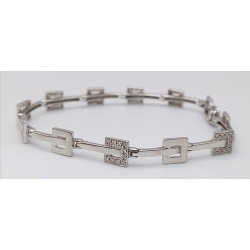 247 - A 9K WHITE GOLD DIAMOND SET BRACELET. 9.9G