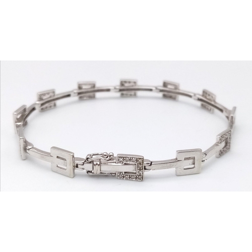 247 - A 9K WHITE GOLD DIAMOND SET BRACELET. 9.9G