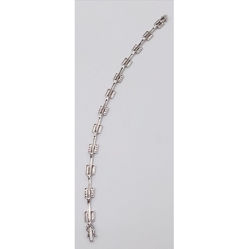 247 - A 9K WHITE GOLD DIAMOND SET BRACELET. 9.9G