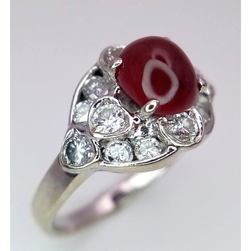 373 - A 9K WHITE GOLD DIAMOND & CABOCHON RUBY RING - 0.40CT. 4.4G. SIZE M