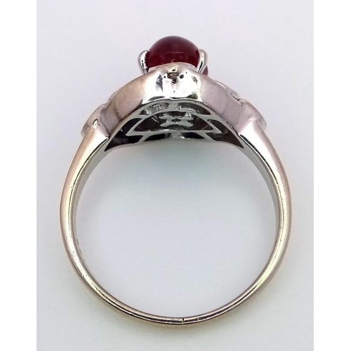 373 - A 9K WHITE GOLD DIAMOND & CABOCHON RUBY RING - 0.40CT. 4.4G. SIZE M