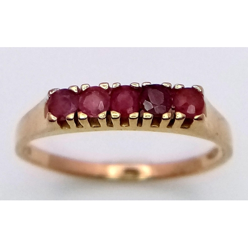 756 - A 9K YELLOW GOLD RUBY 5 STONE RING. 1.6G SIZE M