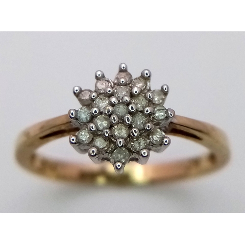 801 - AN 9K YELLOW GOLD DIAMOND CLUSTER RING. 1.6G. SIZE L.