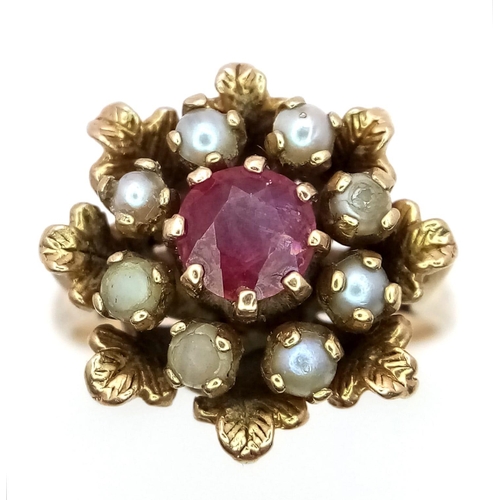 857 - A 9K YELLOW GOLD STONE SET CLUSTER RING. 4.5G. SIZE K (BELIEVED TO BE RUBY AND PEARL).