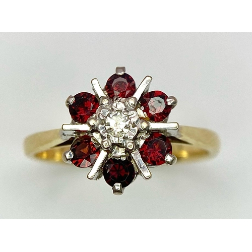 151 - AN 18K YELLOW GOLD DIAMOND & GARNET CLUSTER RING. 3.4G. SIZE L.