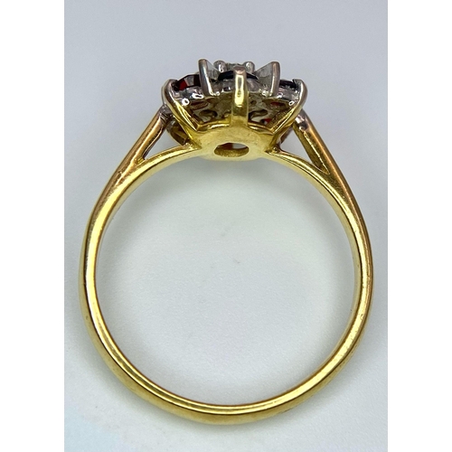 151 - AN 18K YELLOW GOLD DIAMOND & GARNET CLUSTER RING. 3.4G. SIZE L.