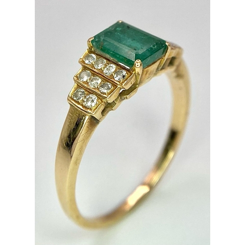 16 - A 9 K yellow gold ring with an emerald cut emerald and round cut diamonds on the solders. Ring size:... 