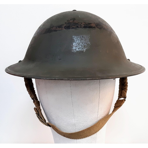 243 - 1943 Dated British MK II Helmet. Original Paint. Makers Marked RO & CO. With original chin strap. Al... 