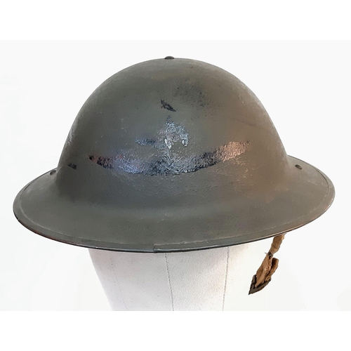 243 - 1943 Dated British MK II Helmet. Original Paint. Makers Marked RO & CO. With original chin strap. Al... 