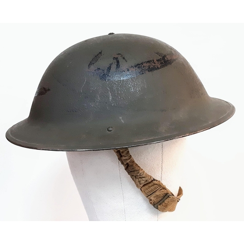 243 - 1943 Dated British MK II Helmet. Original Paint. Makers Marked RO & CO. With original chin strap. Al... 