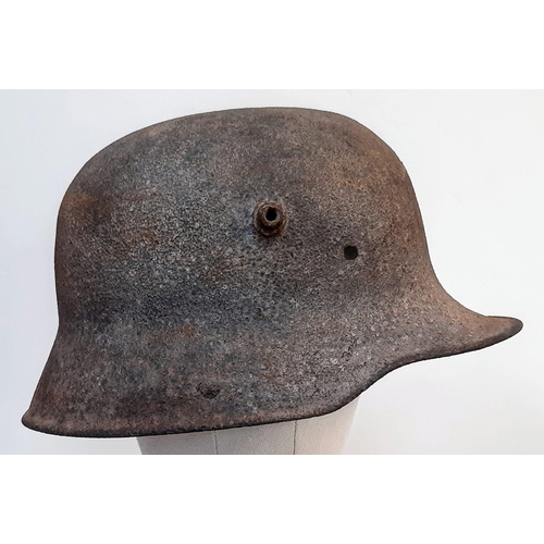 251 - WW1 Battle Damaged German M16 Stahlhelm Helmet. This helmet was found in woodland in the Ypres Salie... 