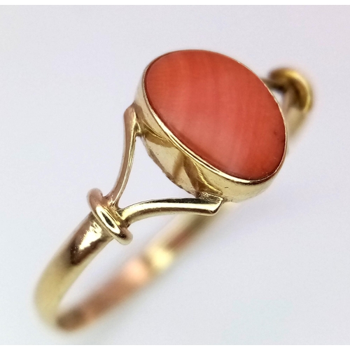 458 - A 9 K yellow gold ring with a red coral cabochon, size: K, weight: 0.7 g.