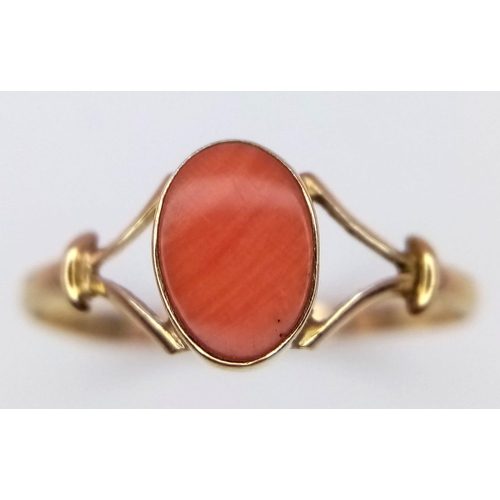 458 - A 9 K yellow gold ring with a red coral cabochon, size: K, weight: 0.7 g.