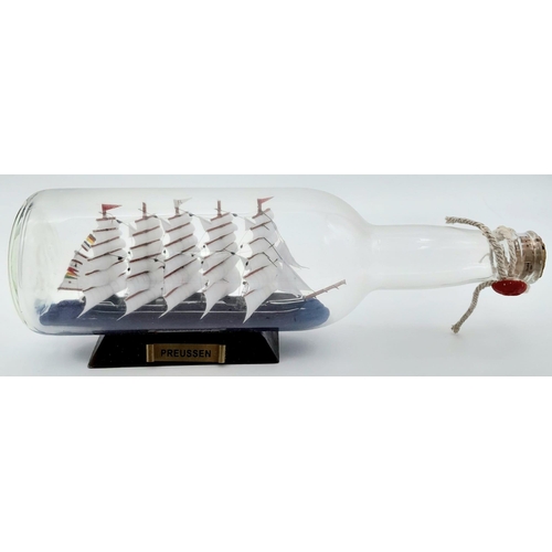 777 - A Ship in a Bottle. Good condition in original packaging. 30cm length.