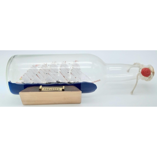 777 - A Ship in a Bottle. Good condition in original packaging. 30cm length.