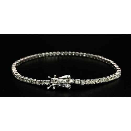 10 - An 18K White Gold Diamond Tennis Bracelet. 62 brilliant round cut diamonds - 4.3ctw. 18cm. 8.2g tota... 