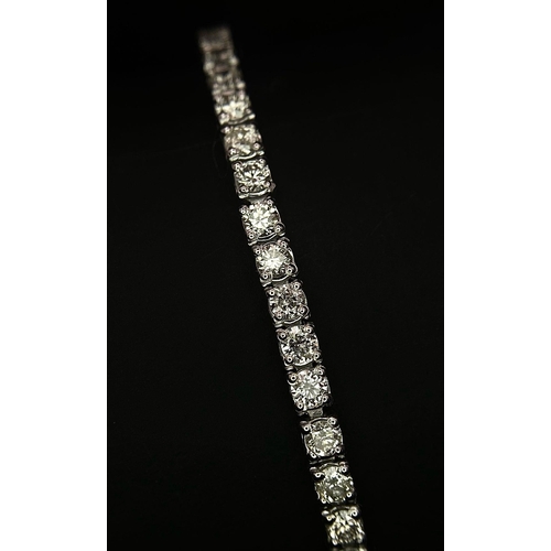 10 - An 18K White Gold Diamond Tennis Bracelet. 62 brilliant round cut diamonds - 4.3ctw. 18cm. 8.2g tota... 