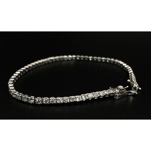 10 - An 18K White Gold Diamond Tennis Bracelet. 62 brilliant round cut diamonds - 4.3ctw. 18cm. 8.2g tota... 