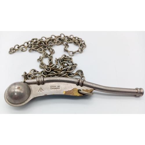 1289 - A WW2 Naval Bosuns Whistle on metal chain lanyard. Marked with a Broad Arrow. 12cm Length.