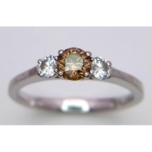 227 - A Browns Designer 18K White Gold and Diamond Trilogy Ring. Central brilliant round cut 0.30ct champa... 