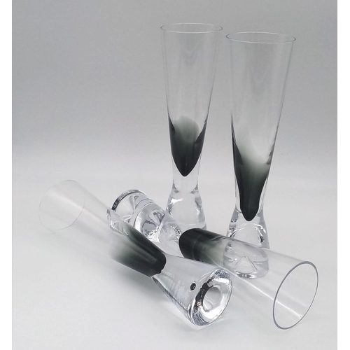 337 - A set of four stylish Tom Dixon tank champagne glasses. In lovely condition. 22.5cm tall.