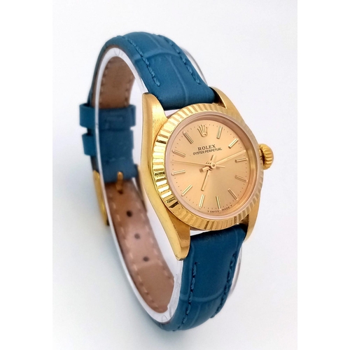 934 - An 18k Gold Rolex Oyster Perpetual Ladies Watch. Blue leather strap. 18k gold case - 25mm. Gold tone... 