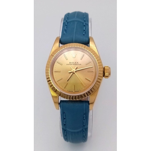 934 - An 18k Gold Rolex Oyster Perpetual Ladies Watch. Blue leather strap. 18k gold case - 25mm. Gold tone... 