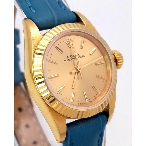 934 - An 18k Gold Rolex Oyster Perpetual Ladies Watch. Blue leather strap. 18k gold case - 25mm. Gold tone... 