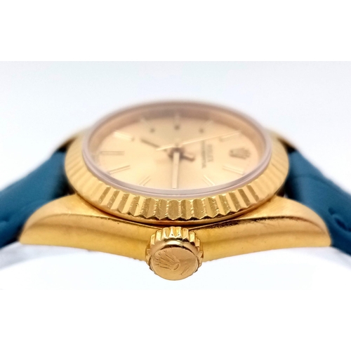 934 - An 18k Gold Rolex Oyster Perpetual Ladies Watch. Blue leather strap. 18k gold case - 25mm. Gold tone... 