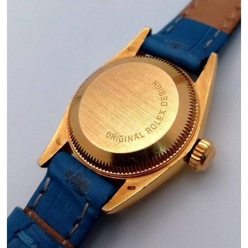 934 - An 18k Gold Rolex Oyster Perpetual Ladies Watch. Blue leather strap. 18k gold case - 25mm. Gold tone... 