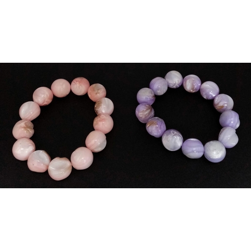 493 - A Purple and a Pink Polished Conch Shell Expandable Bracelet.