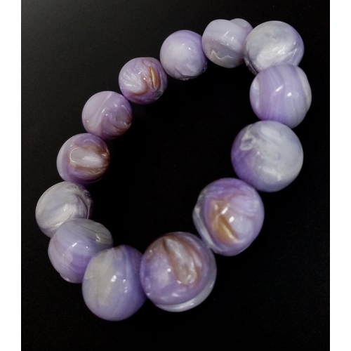 493 - A Purple and a Pink Polished Conch Shell Expandable Bracelet.